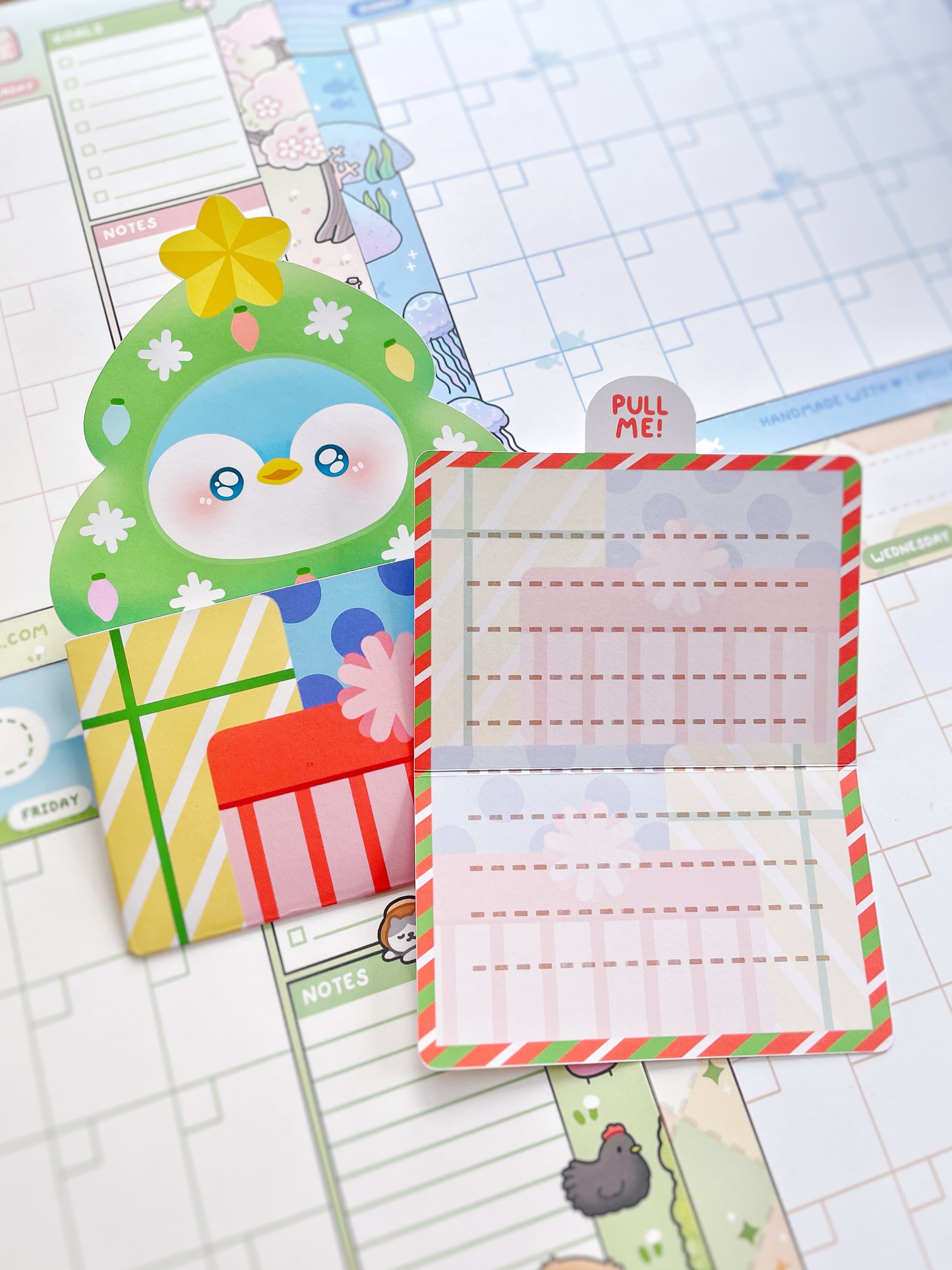 Colorful planner stickers with a penguin design on a grid background